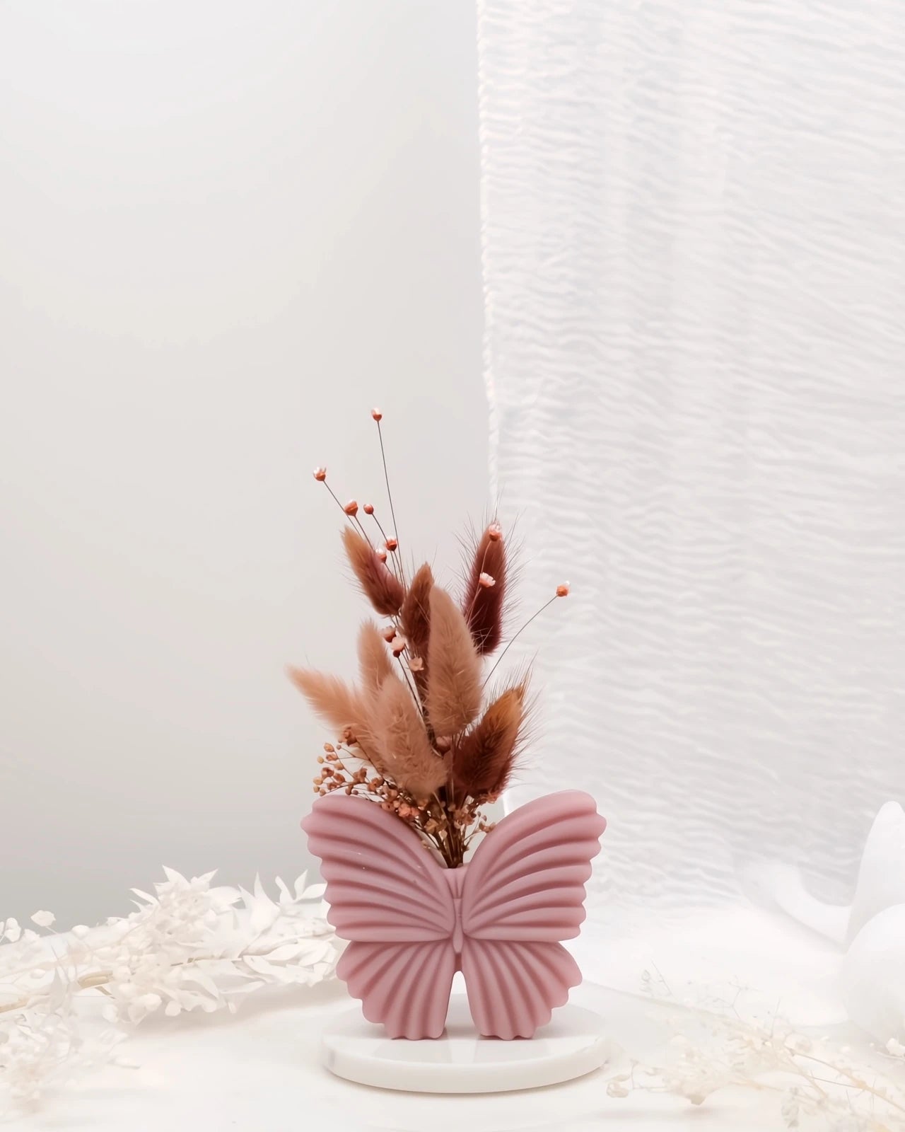 Vaso di cera a forma di farfalla con bouquet di fiori secchi e stabilizzati, creazione artigianale simbolo di rinascita color rosa antico cipria